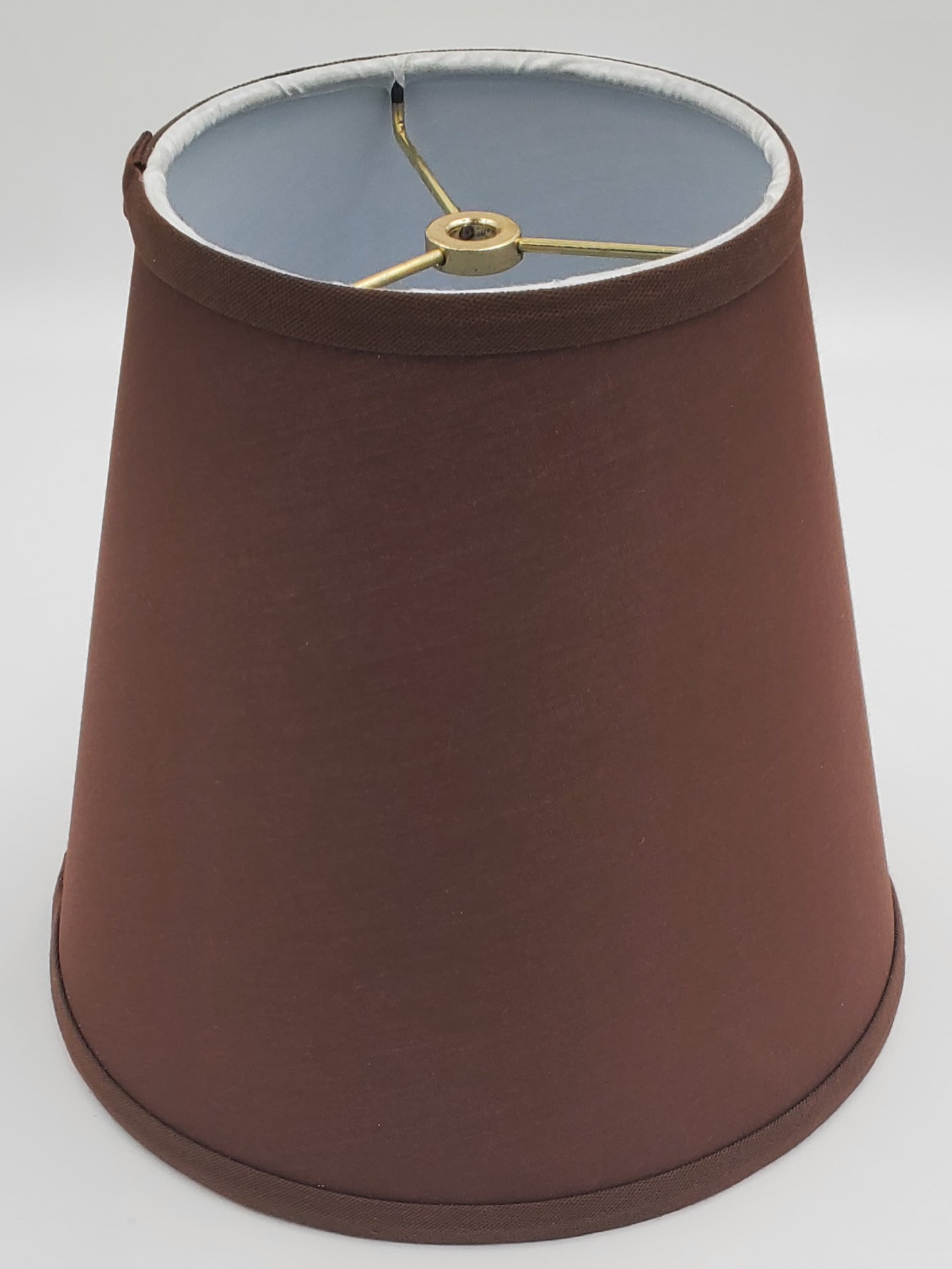 Mahogany fabric empire lampshade with white interior lining and brass spider fitter, 9" side height